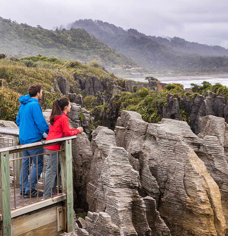 Punakaiki Pancake Rocks tourists couple travel in Paparoa National Park